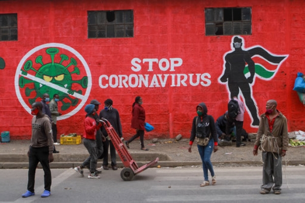 Kenyans walk past a mural about the coronavirus, Haile Selassie Avenue, Nairobi. Press Association.jpg