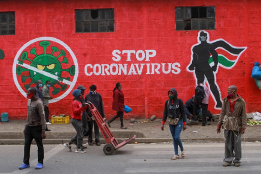 Kenyans walk past a mural about the coronavirus, Haile Selassie Avenue, Nairobi. Press Association