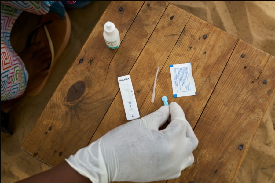 A malaria test being performed by medics financed by Global Fund.