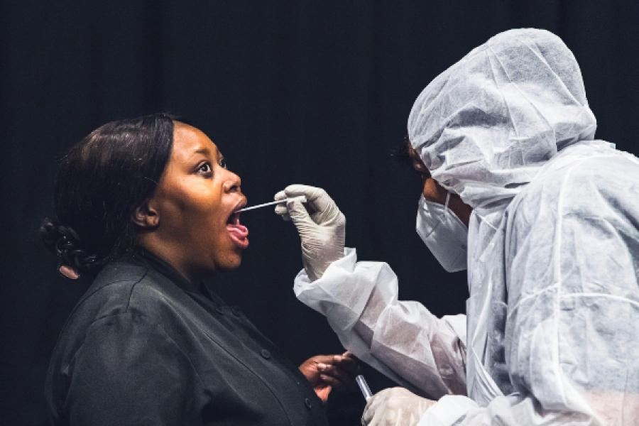 Women being tested for viral infection with a swab in her throat in Johannesburg, South Africa, on February 4, 2021. Alamy