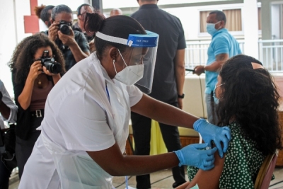 A medic injects the first dose of the Chinese Covid-19 vaccine produced by Sinopharm in the Seychelles