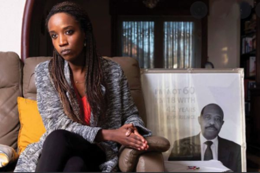 Carine Kanimba poses with a photo of her Hotel Rwanda hero father.