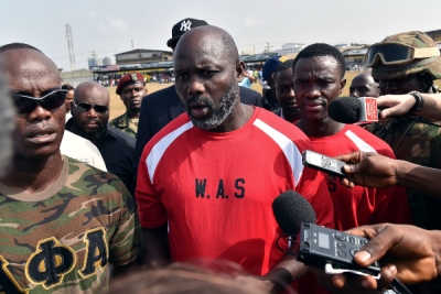 Liberian president George Weah being interviewed by reporters. Getty.