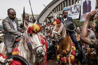 Horsemen are pushed back by soldiers as supporters of the Ethiopian Prime Minister Abiy Ahmed push through the gate to enter the stadium in Jimma where the prime minister was scheduled for an election rally. Getty.