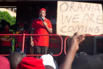 Julius Malema of the Economic Freedom Fighters addresses a rally holding racist placards targeting the white farming community Orania.