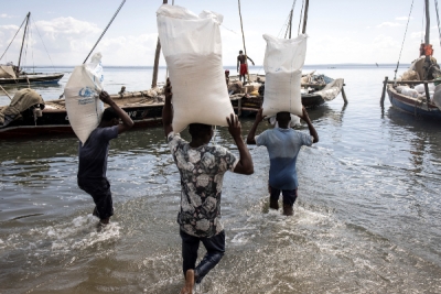Feeding refugees: Men carry sacks of rice to a boat in Pemba in war-torn Mozambique, on May 21, 2021. 