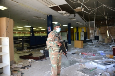 South African security services in the looted ruins of a shopping centre.