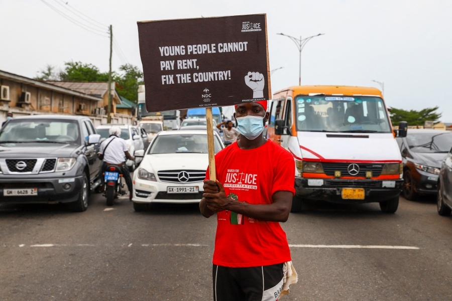 A demonstrator holds an anti-government placard during #FixTheCountry protests in Accra on July 6, 2021. The protests were partly sparked by lower living standards caused by Covid lockdowns.