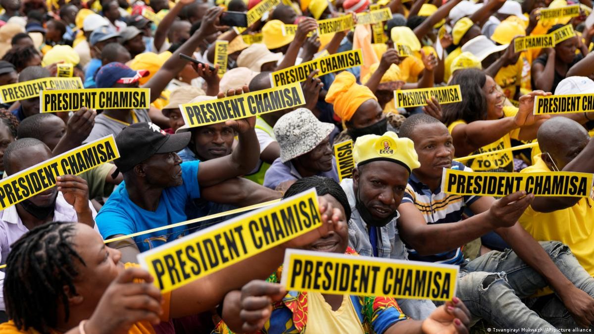 Supporters of Zimbabwe's opposition leader Nelson Chamisa holding signs.